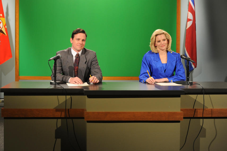 Michael Mosley and Elizabeth Banks sit behind a news desk