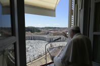 Pope Francis delivers his blessing from his studio window overlooking St. Peter's Square at the Vatican, Sunday, May 31, 2020. Francis celebrated a Pentecost Mass in St. Peter's Basilica on Sunday, albeit without members of the public in attendance. He will then went to his studio window to recite his blessing at noon to the crowds below. The Vatican says police will ensure the faithful gathered in the piazza keep an appropriate distance apart. (Vatican News via AP)