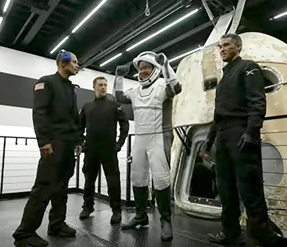 In this image taken from video, Chris Sembroski, one of four passengers aboard the SpaceX capsule, reacts after emerging from the capsule Saturday, Sept. 18, 2021, after it was recovered following its splashdown in the Atlantic off the Florida coast. The all-amateur crew was the first to circle the world without a professional astronaut. (Inspiration4 via AP)