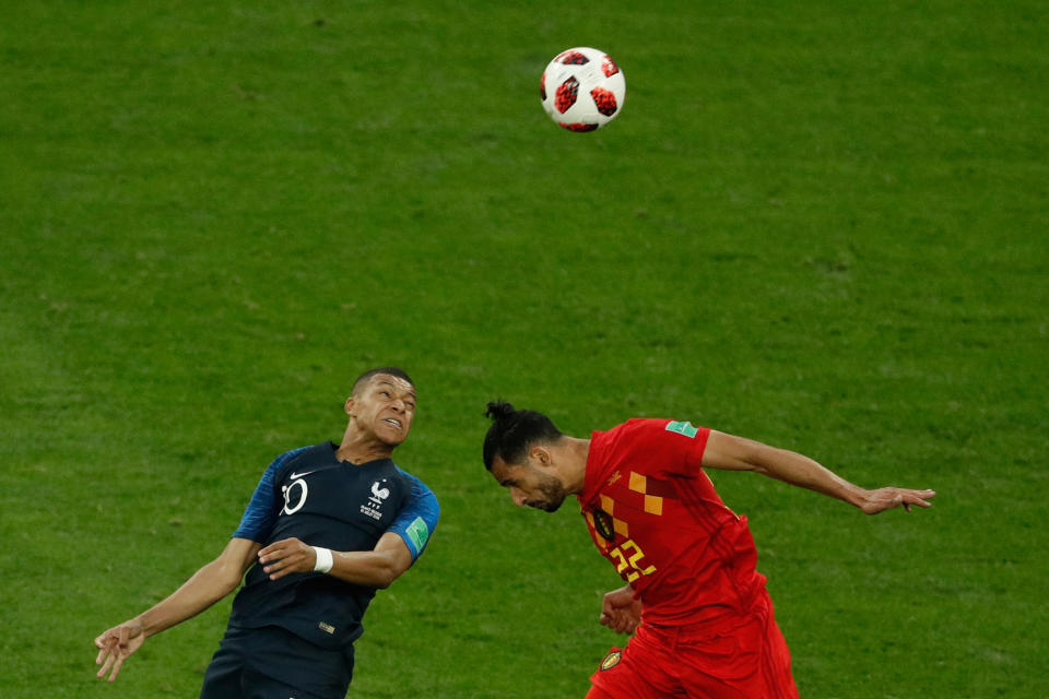 <p>France’s forward Kylian Mbappe (L) heads the ball as he vies for it with Belgium’s midfielder Nacer Chadli during the Russia 2018 World Cup semi-final football match between France and Belgium at the Saint Petersburg Stadium in Saint Petersburg on July 10, 2018. (Photo by Adrian DENNIS / AFP) </p>