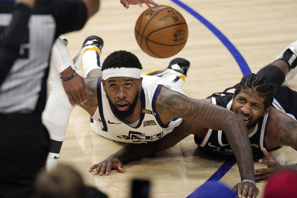 Utah Jazz forward Royce O'Neale, left, and Los Angeles Clippers guard Paul George go after a loose ball during the second half in Game 6 of a second-round NBA basketball playoff series Friday, June 18, 2021, in Los Angeles. (AP Photo/Mark J. Terrill)