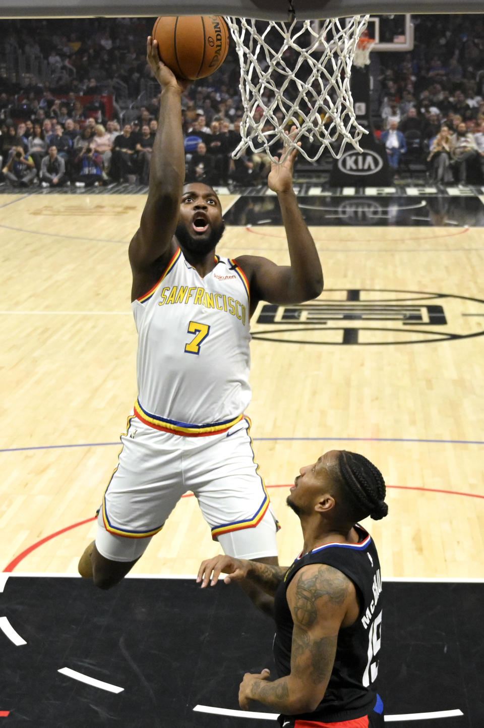 Golden State Warriors forward Eric Paschall shoots as Los Angeles Clippers guard Rodney McGruder defends during the first half of an NBA basketball game Friday, Jan. 10, 2020, in Los Angeles. (AP Photo/Mark J. Terrill)