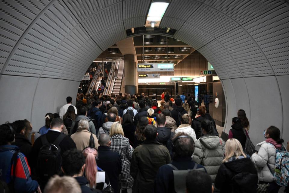 Commuters try to leave Tottenham Court Road station in London (AFP via Getty Images)