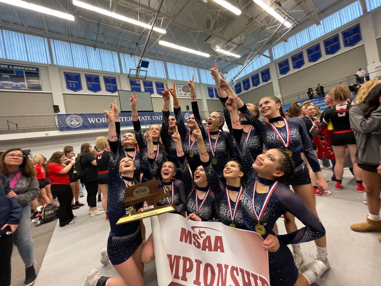 The Medway High cheerleading team celebrates its state championship at Worcester State University on March 10.