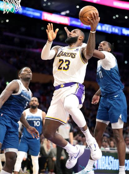 Los Angeles, California March 10, 2024-Lakers LeBron James beats Timberwolves Naz Reid.