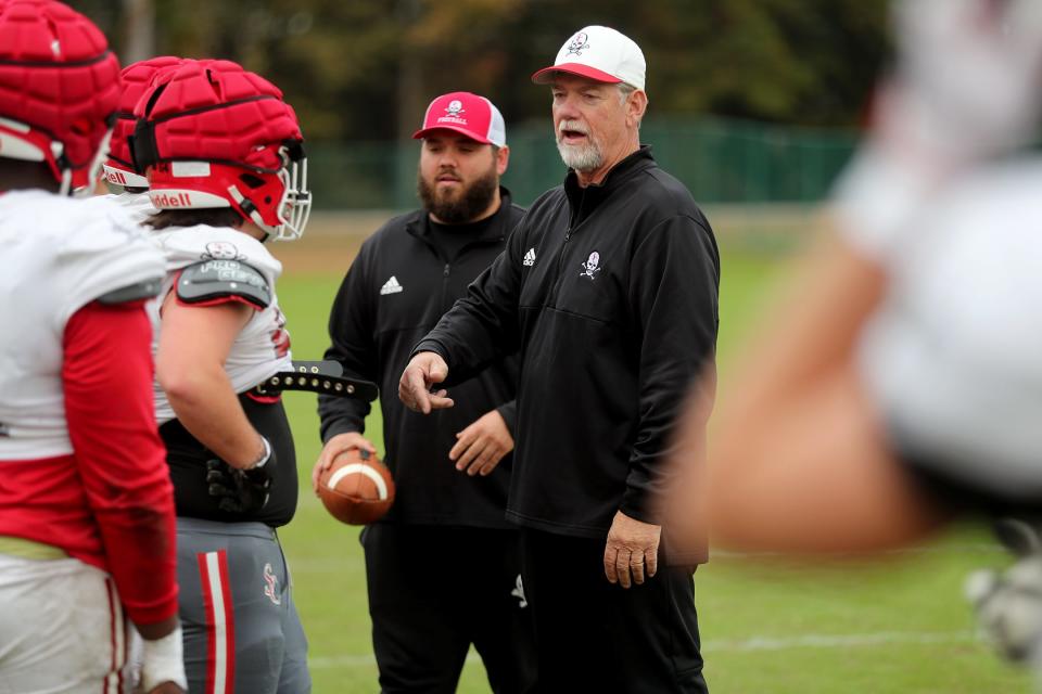 Savannah Christian coaches Kempie Womble, right, and his son Caleb talk with players during practice on Tuesday, November 14, 2023.