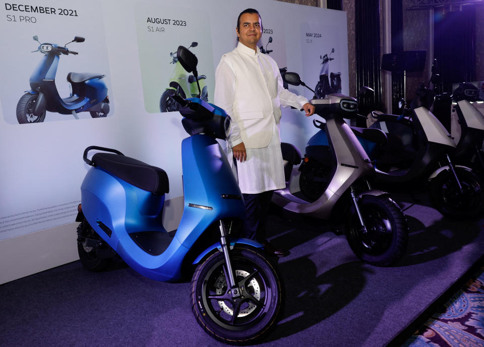 Bhavish Aggarwal, CEO of Ola Cabs, and founder of Ola Electric, poses with Ola electric scooters after the press conference ahead of the company's IPO launch in Mumbai, India, July 29, 2024. REUTERS/Francis Mascarenhas