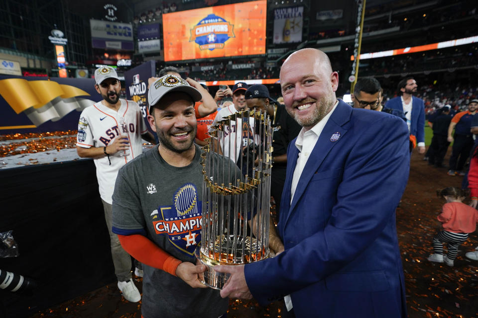 Houston Astros second baseman Jose Altuve and general manager James click celebrate with the trophy after their 4-1 World Series win against the Philadelphia Phillies in Game 6 on Saturday, Nov. 5, 2022, in Houston. (AP Photo/David J. Phillip)