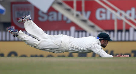 Australia's Glenn Maxwell dives to stop the ball. REUTERS/Adnan Abidi