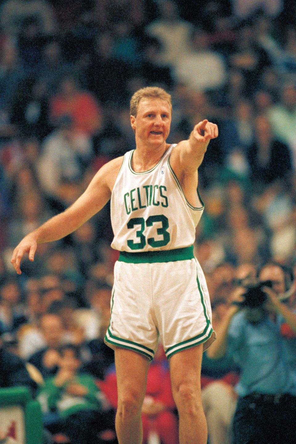 Boston Celtics forward Larry Bird compliments a teammate for a nice pass after Bird scored during first half NBA action at Boston Garden on Sunday, March 1, 1992, against the Dallas Mavericks.