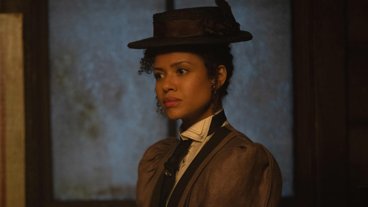  Gugu Mbatha-Raw stands in dim light dressed in an 1800s in Loki Season 2. 