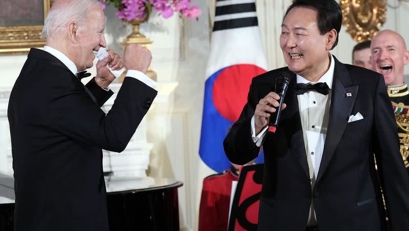 President Joe Biden reacts as South Korea’s President Yoon Suk Yeol sings the song “American Pie” by Don Mclean in the State Dining Room of the White House in Washington, Wednesday, April 26, 2023.