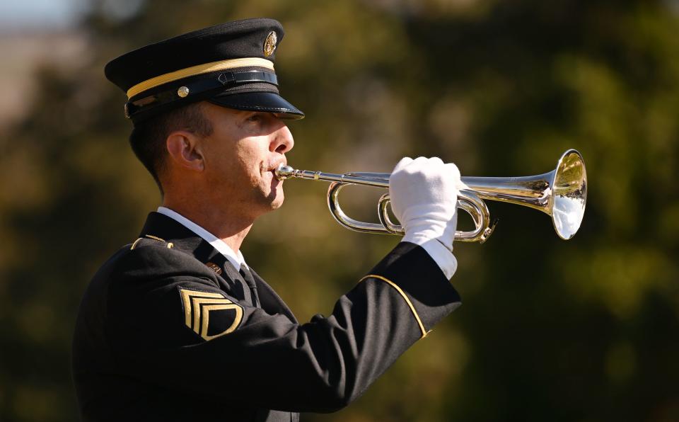 Staff Sgt. Aaron Reynolds of the 23rd Army Band Utah National Guard plays taps for President M. Russell Ballard’s graveside service in the Salt Lake City Cemetery on Friday, Nov. 17, 2023. | Scott G Winterton, Deseret News