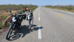 Jamie與重機合照 | Jamie is pictured with their second-hand motorbike. (Courtesy of Jamie Huang/黃麗仰)