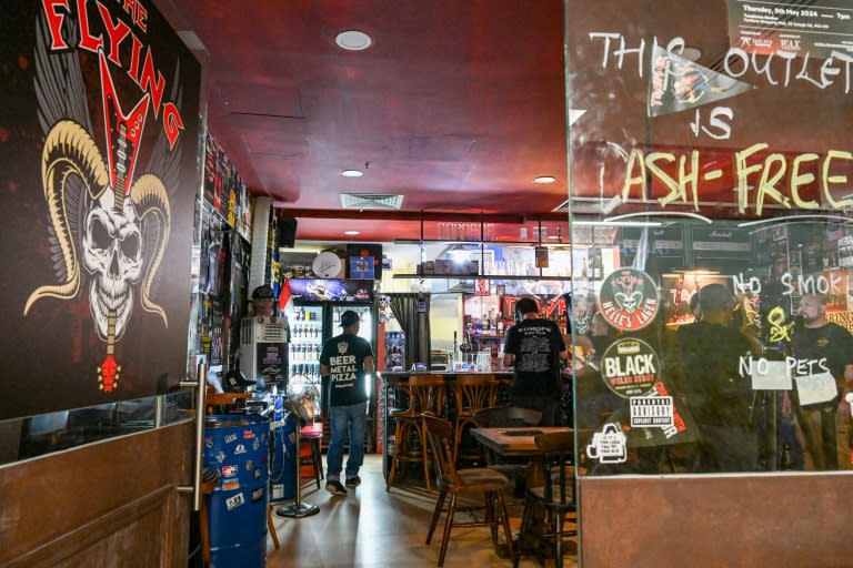 Tucked away in the basement of an old mall lies gleaming Singapore's only heavy metal bar, where music fans brush shoulder-to-shoulder with international rockers (Roslan RAHMAN)