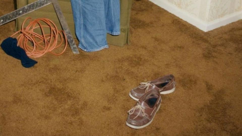 A crime scene photo shows a pair of boat shoes, like her husband was known to wear, by Cathy Krauseneck's bed. Forty years later, detectives believe the faint shoe print in that garbage bag was made by those boat shoes, which were not tested. / Credit: Monroe County District Attorney's Office