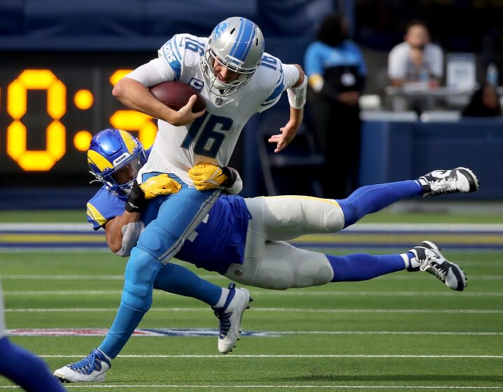 INGLEWOOD, CALIF. - OCT. 24, 2021. Lions quarterback Jared Goff is brought down.