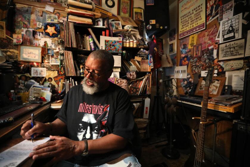 CARSON, CA - NOVEMBER 2, 2023 - Duane Lance Filer, 71, writes notes for a possible subject of a new book at the desk where he has written nine novels in the "Fffunk Lab" at his home in Carson on November 2, 2023. After retiring from the State of California Public Utilities Commission in 2013 Filer decided to start writing books. He's currently finishing his tenth book. His first book is, "The Baby Boomers First-Hand, First-Year Guide to Retirement - 365 Days of Bliss (????!!!) or Diss (not???!!!)." His work is inspired by his family, his imagination and the music of Funk that fuels his creativity. (Genaro Molina / Los Angeles Times)