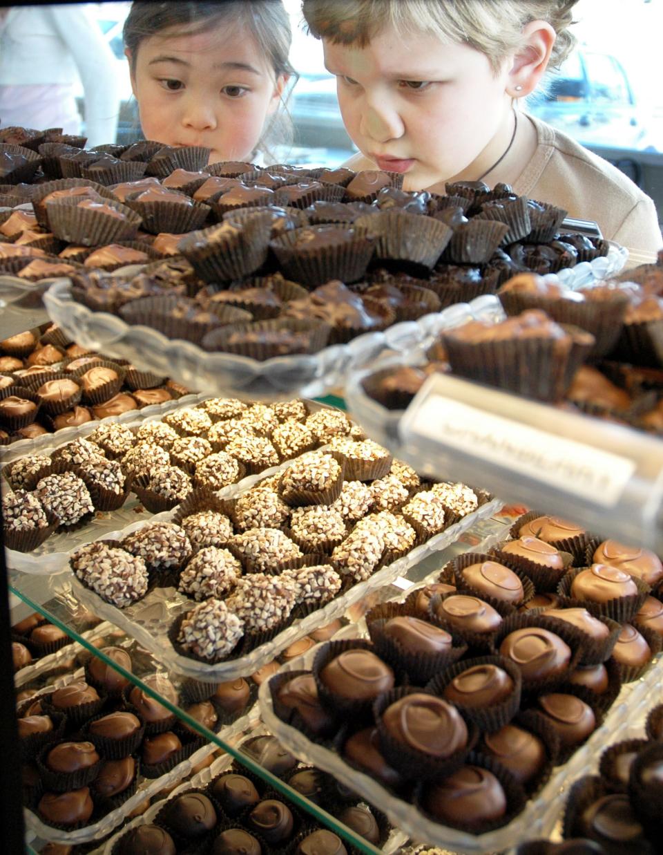 Customers Leena Maxey, right, and Bridget Murphy oogle the wide array of fine chocolates with hopeful eyes at Hatch Family Chocolates on March 10, 2006. | Mike Terry for the Deseret News