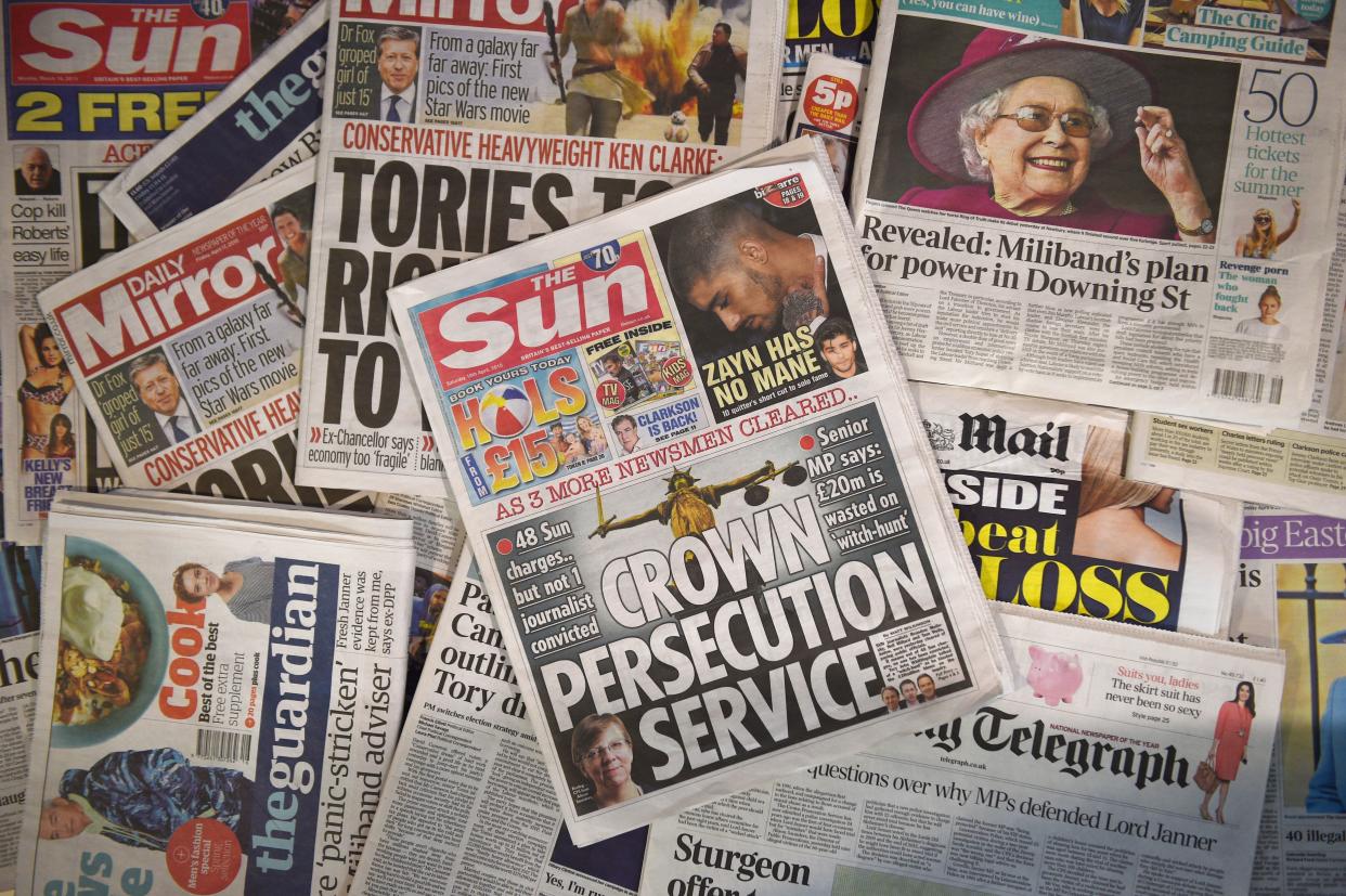 A picture taken in London on April 18, 2015 shows an arrangement of British newspapers and an edition of the Sun newspaper carrying a front page story about the collapse of prosecutions by the Crown Prosecution Service (CPS) under the police's Operation Elveden.  Villified for their dark arts since the phone-hacking scandal, Britain's popular press won a victory this week after prosecutors acknowledged that the long-held practice of paying sources for stories was legitimate. Paying for stories has long been common in the British media, and many of the journalists prosecuted said they had no idea they might have been committing a crime. Britain's top-selling newspaper, The Sun, has said there was a "witch-hunt" against its journalists and in a front page Saturday condemned the "Crown Persecution Service".  AFP PHOTO / DANIEL SORABJI        (Photo credit should read DANIEL SORABJI/AFP/Getty Images)