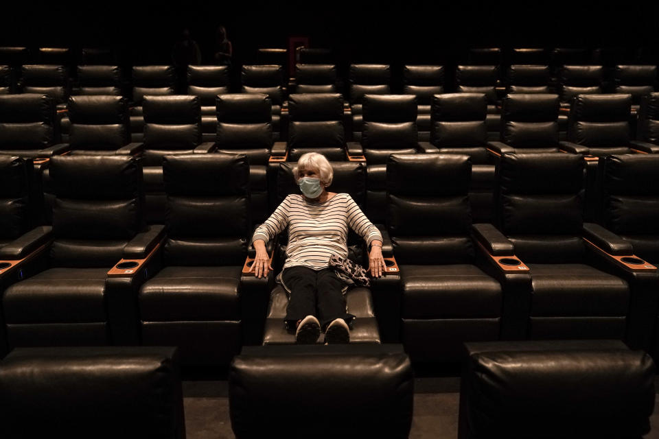 FILE - In this Sept. 8, 2020, file photo, Karen Speros, 82, waits for a movie to start at a Regal movie theater in Irvine, Calif. (AP Photo/Jae C. Hong, File)