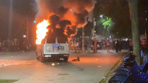 In this photo provided by Khadijah, flames erupt from a New York City Police Department van set ablaze, Friday, May 29, 2020, in the Brooklyn borough of New York, during a protest of the death of George Floyd in police custody on Memorial Day in Minneapolis. (Khadijah via AP)