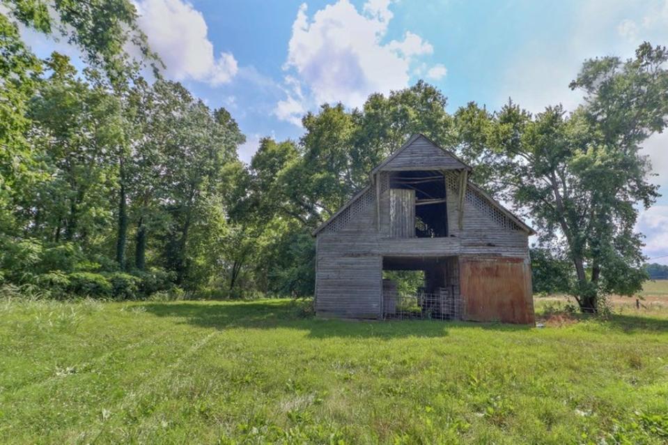 An old barn is also included in the listing, once used for livestock trading (Fathom Realty)