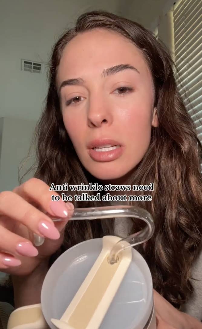 Woman holding a wrinkle-prevention straw, text reads "Anti wrinkle straws need to be talked about more"