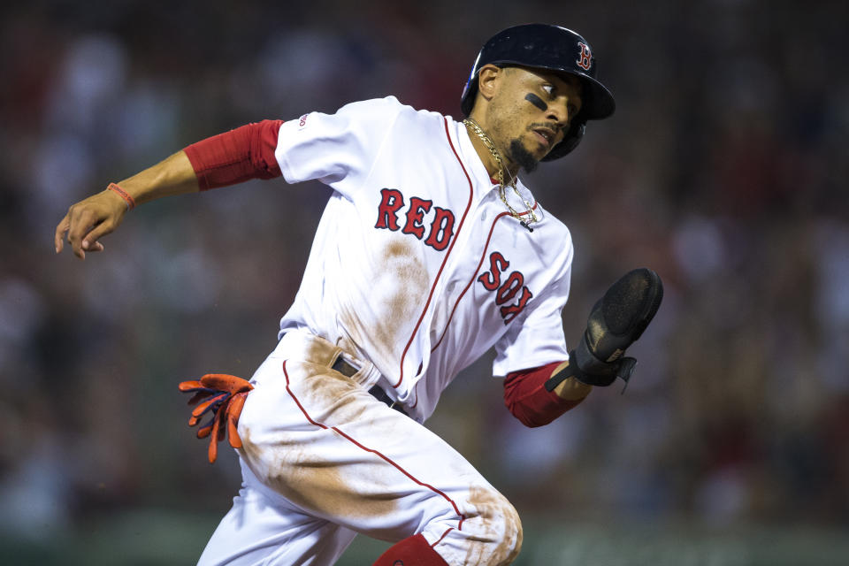 BOSTON - JULY 16: Boston Red Sox right fielder Mookie Betts (50) rounds third base on his way to score during the bottom of the fifth inning. The Boston Red Sox host the Toronto Blue Jays in a regular season MLB baseball game at Fenway Park in Boston on July 16, 2019. (Photo by Nic Antaya for The Boston Globe via Getty Images)