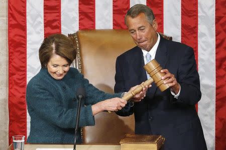 U.S. House Speaker John Boehner (R-OH) (R) takes the gavel from House Minority Leader Nancy Pelosi (D-CA) after being re-elected speaker on the House floor at the U.S. Capitol in Washington January 6, 2015. REUTERS/Jonathan Ernst