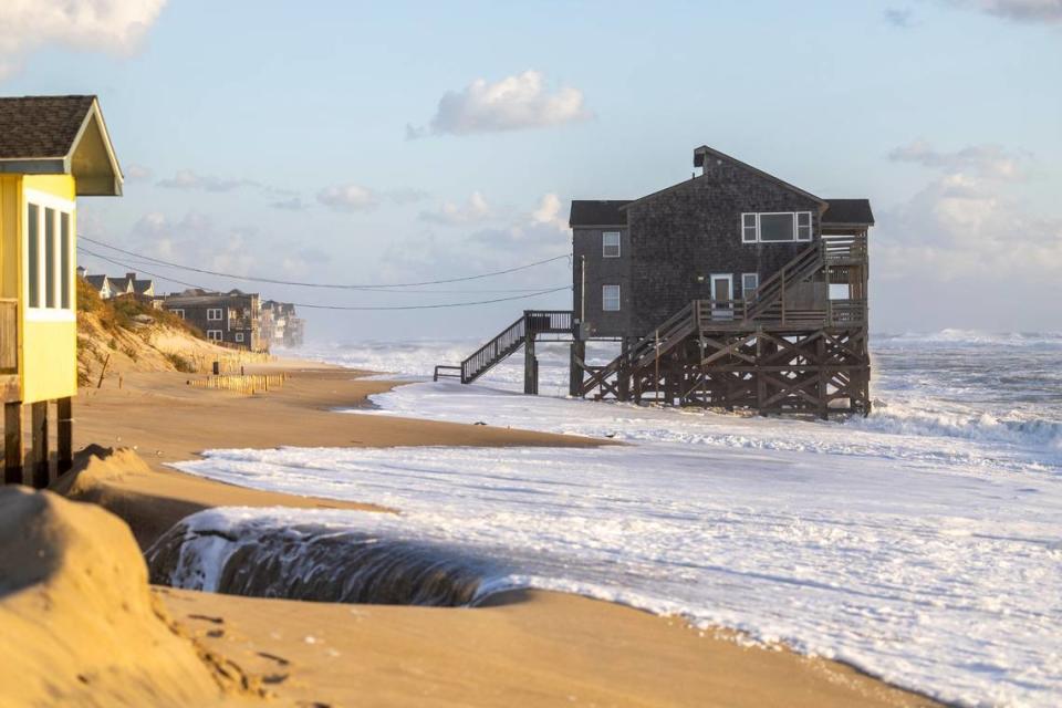 Ocean overwash settles in the street behind beach homes in Rodanthe Friday, Sept, 15, 2023 as Hurricane Lee churns in the Atlantic hundreds of miles offshore.