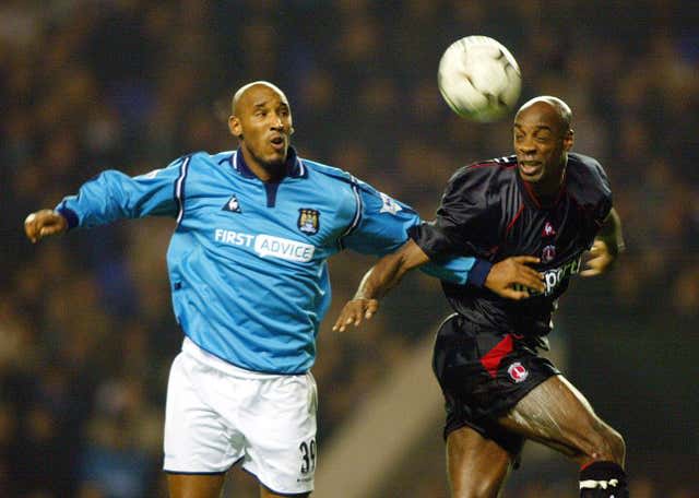 Rufus, right, beats Manchester City’s Nicolas Anelka to a header