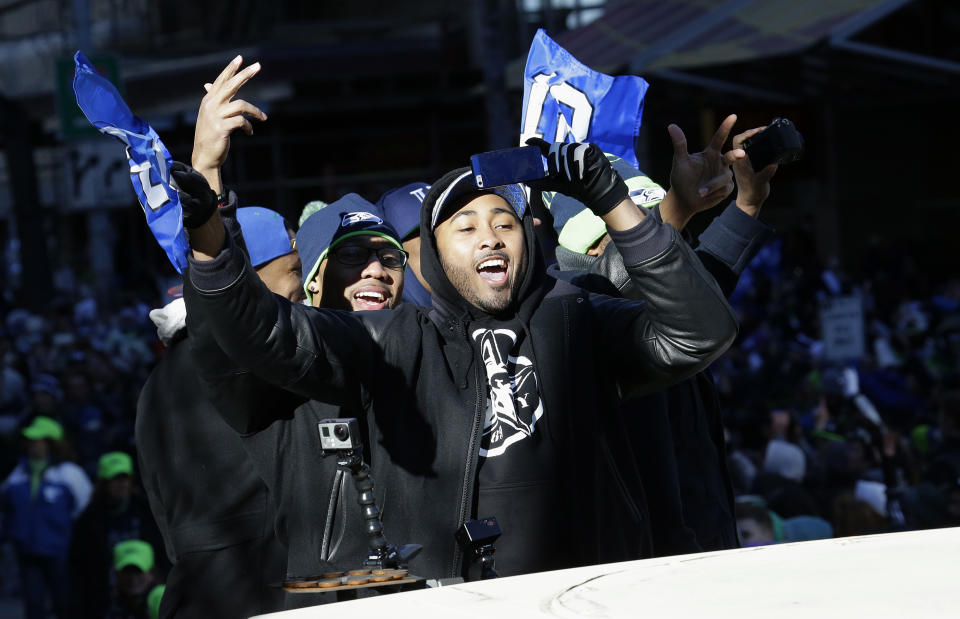 Seattle Seahawks linebacker and Super Bowl MVP Malcolm Smith gestures to fans during the Super Bowl champions parade, Wednesday, Feb. 5, 2014, in Seattle. The Seahawks defeated the Denver Broncos 43-8 in NFL football's Super Bowl XLVIII on Sunday. (AP Photo/Ted S. Warren)