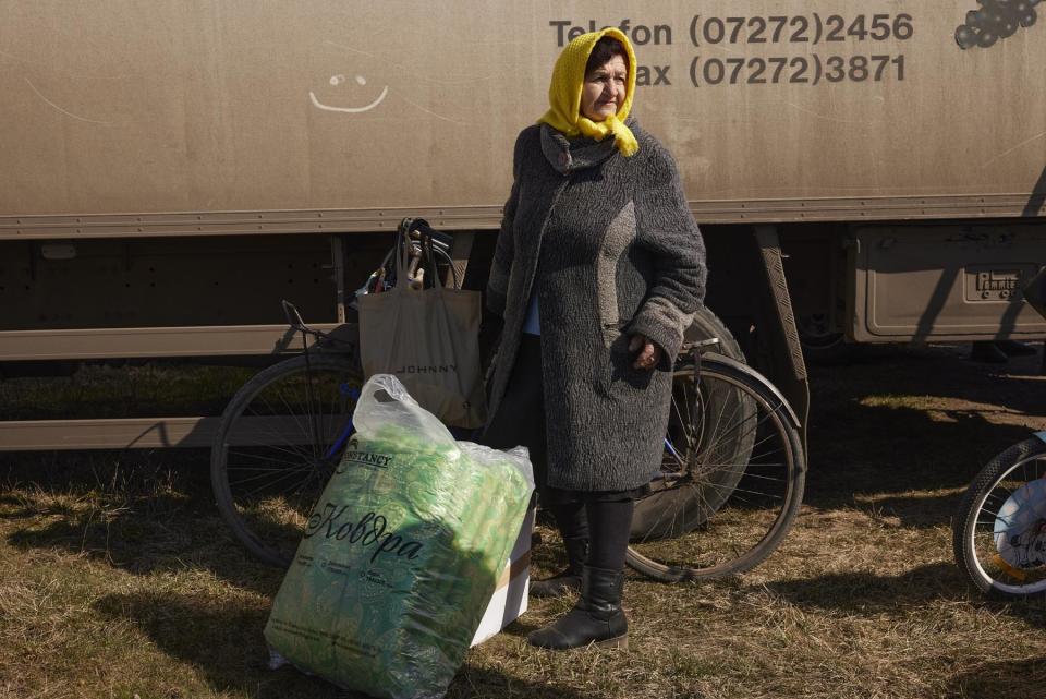 Alla Ivanova, a local nurse stands with a New Dawn aid delivery package in Pravdyne, Kherson Oblast, Ukraine on March 8, 2023.