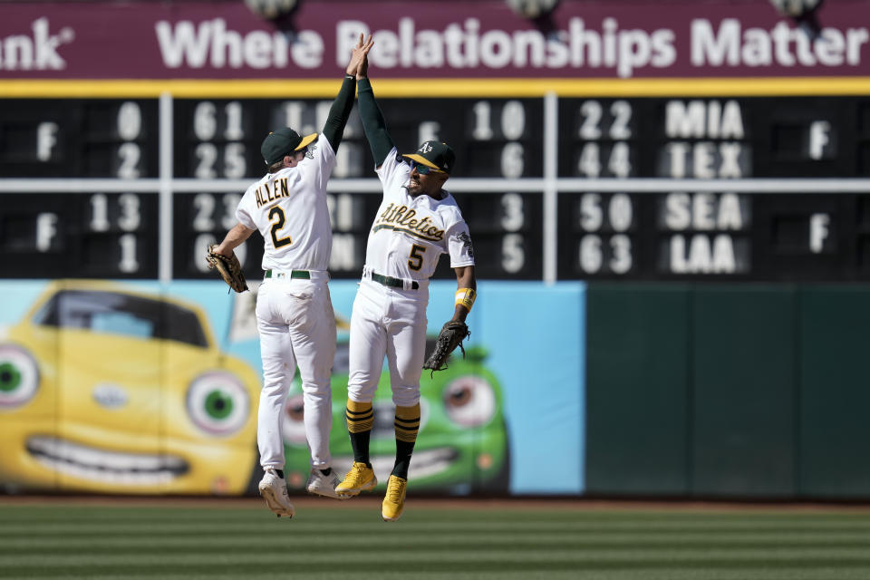 Oakland Athletics shortstop Nick Allen, left, and second baseman Tony Kemp celebrate after theirvictory over the San Francisco Giants in a baseball game Sunday, Aug. 6, 2023, in Oakland, Calif. (AP Photo/Godofredo A. Vásquez)