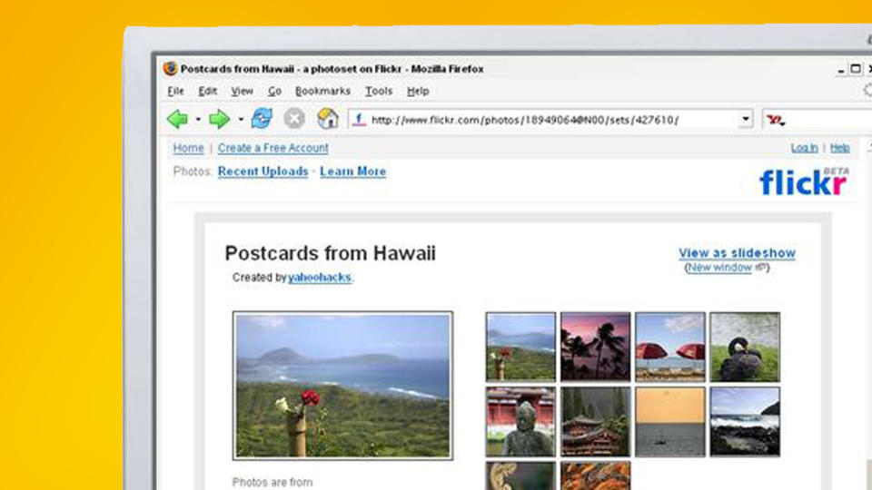 A monitor on a yellow background showing Flickr in 2004