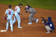 Minnesota Twins shortstop Jorge Polanco (11) plays to the cameras after the Twins defeated the Cincinnati Reds 7-3 in a baseball game Saturday, Sept. 26, 2020, in Minneapolis. (AP Photo/Jim Mone)