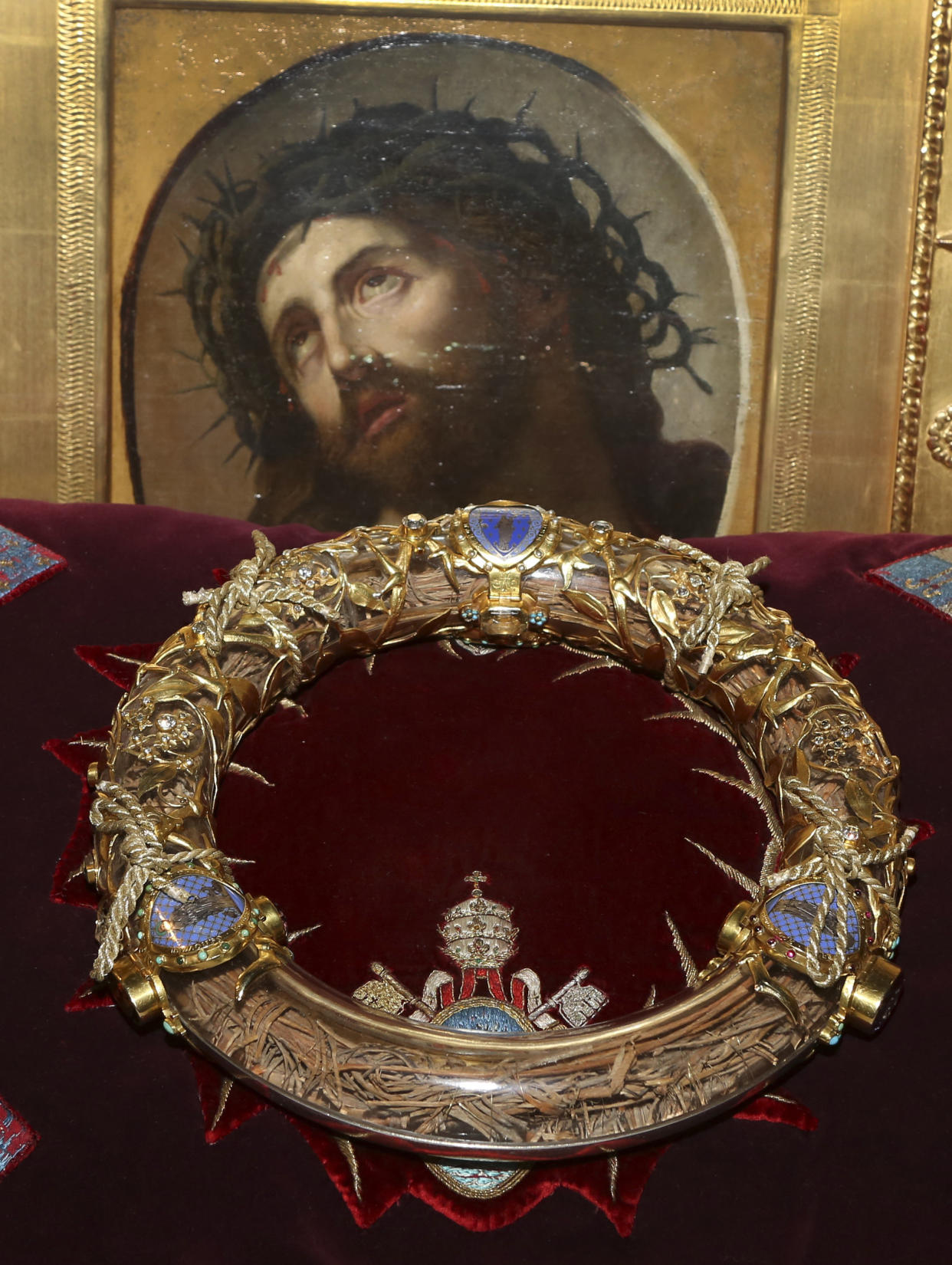 FILE - In this Friday March 21, 2014 file photo a crown of thorns which was believed to have been worn by Jesus Christ and which was bought by King Louis IX in 1239 is presented at Notre Dame Cathedral in Paris. Paris' mayor, Anne Hidalgo, said a significant collection of art and holy objects inside the church had been recovered from the fire at Notre Dame cathedral. In a tweet later, she thanked firefighters and others who formed a human chain to save artifacts. "The crown of thorns, the tunic of St. Louis and many other major artifacts are now in a safe place," she wrote. (AP Photo/Remy de la Mauviniere, File)