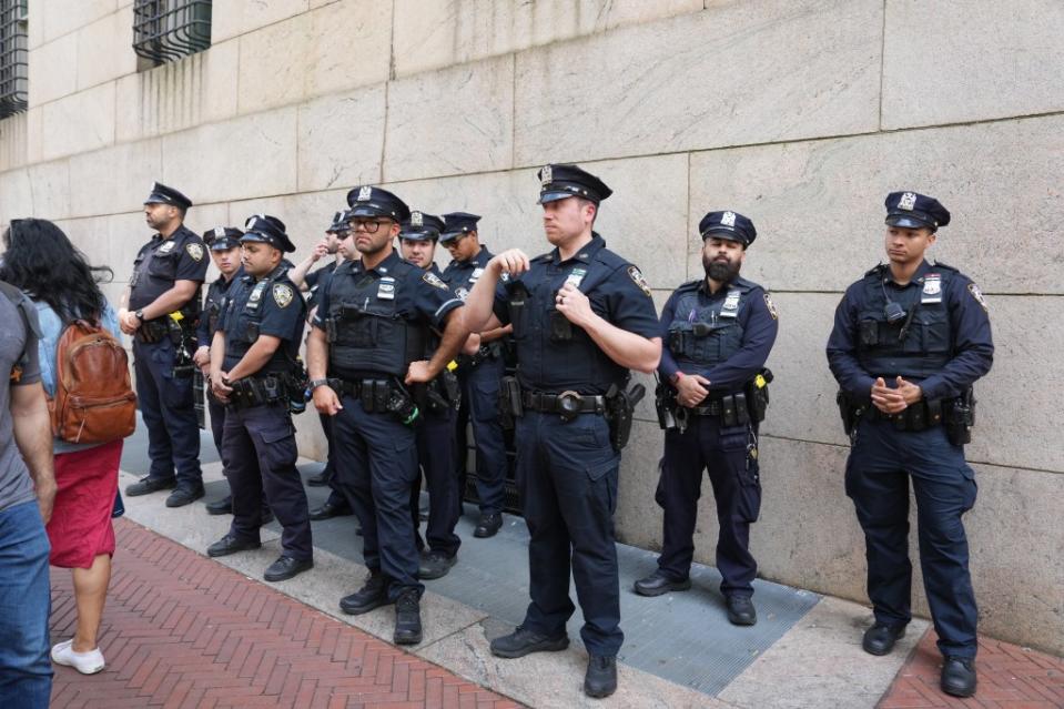 Members of the New York Police Department stand ready to clear out the Columbia encampment. James Keivom