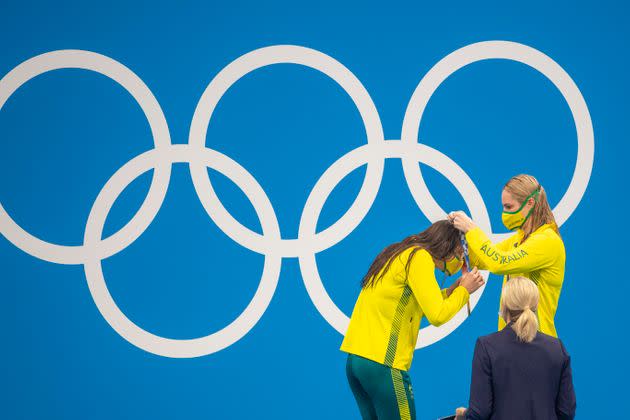 Kaylee McKeown of Australia, left, receives her gold medal in women's 200 meter backstroke from Australia's Emily Seebohm, who won the bronze, on July 31. (Photo: Tim Clayton - Corbis via Getty Images)