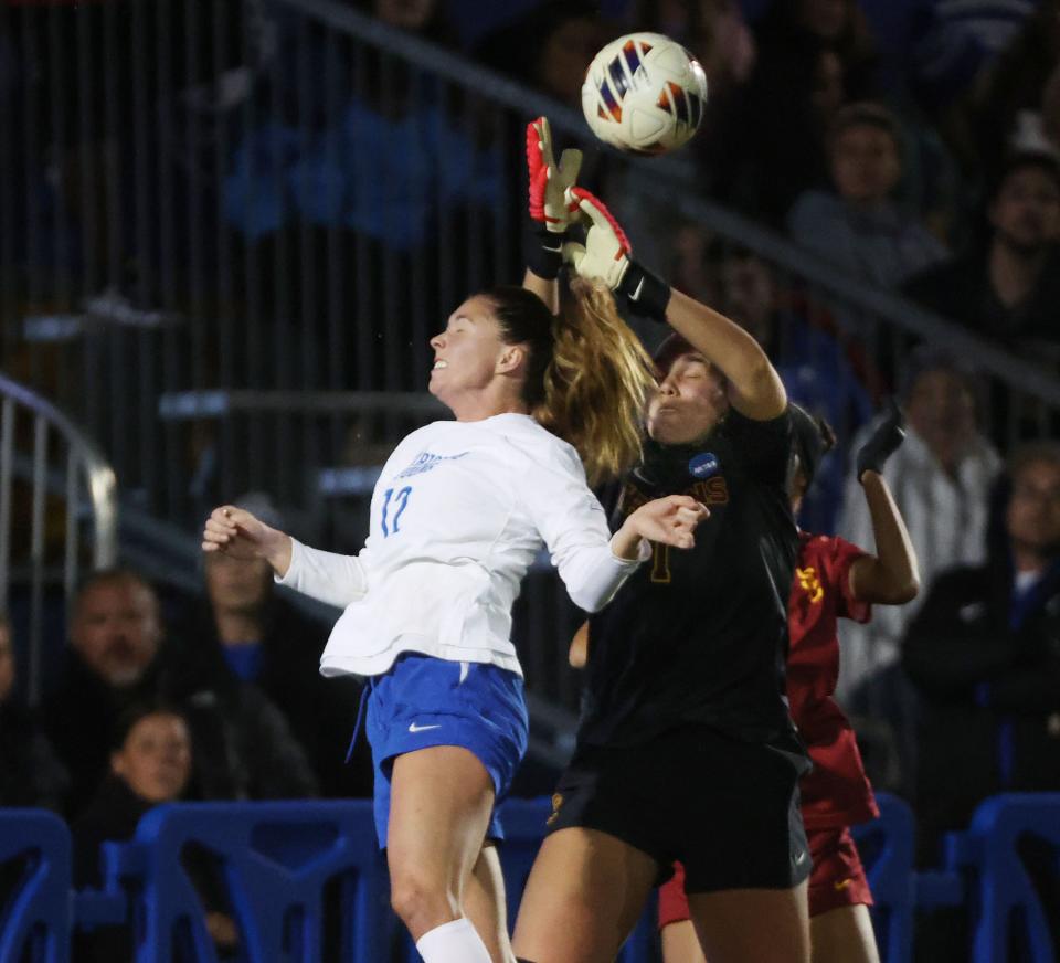 BYU midfielder Jamie Shepherd (12) and USC goalkeeper Hannah Dickinson (1) compete for the ball during the second round of the NCAA championship in Provo on Thursday, Nov. 16, 2023. BYU won 1-0. | Jeffrey D. Allred, Deseret News