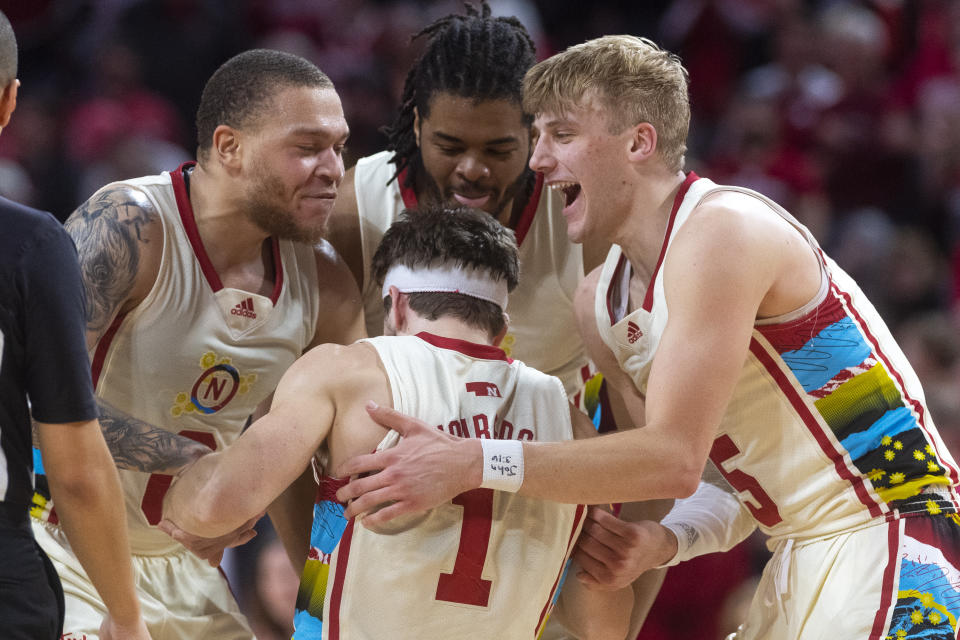 Nebraska's Sam Hoiberg (1) is helped up by his team after hustling after a loose ball the second half of an NCAA college basketball game against Minnesota, Saturday, Feb. 25, 2023, at Pinnacle Bank Arena in Lincoln, Neb. (Kenneth Ferriera/Lincoln Journal Star via AP)