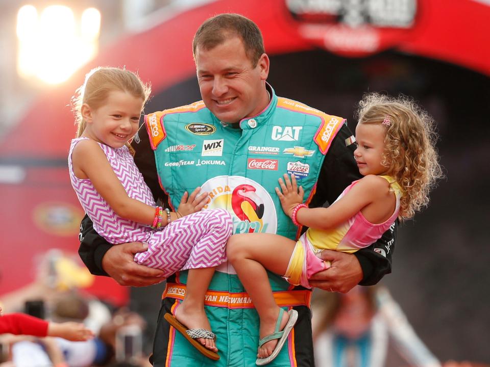 Ryan Newman holds his daughters Brooklyn, left, and Ashlyn during driver introductions before the start of the NASCAR Sprint Cup auto race at Daytona International Speedway, Saturday, July 2, 2016, in Daytona Beach, Florida.