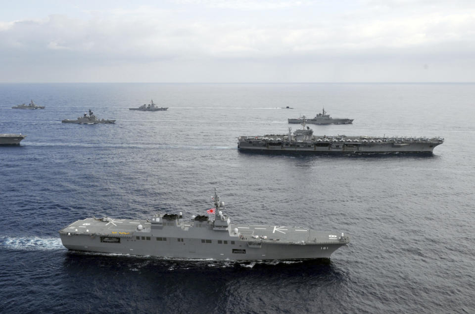 In this photo taken Nov. 16, 2012 and released by U.S. Navy, the USS George Washington aircraft carrier, second row from bottom right, and JS Hyuga, bottom, cruise with other ships from the U.S. Navy and the Japan Maritime Self-Defense Force in East China Sea after the conclusion of Keen Sword, a biennial naval exercise by the two countries to respond to a crisis in the Asia-Pacific region. As U.S. President Barack Obama tours Asia to push his year-old pivot to the Pacific policy, the big question on everybody's mind is how much of a role Washington, with its mighty military and immense diplomatic clout, can play in keeping the Pacific. Japan is Washington's most faithful security partner in the Pacific and it is the most pinched by China's rise. (AP Photo/U.S. Navy, Chief Mass Communication Specialist Jennifer A. Villalovos) EDITORIAL USE ONLY