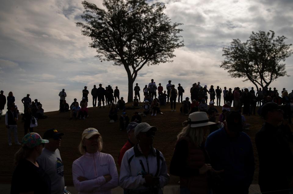 A gallery forms on the hillside of the first tee of the Pete Dye Stadium Course as leaders Nick Dunlap, Sam Burns and Justin Thomas are due to arrive to start the final round of The American Express at PGA West in La Quinta, Calif., Sunday, Jan. 21, 2024.