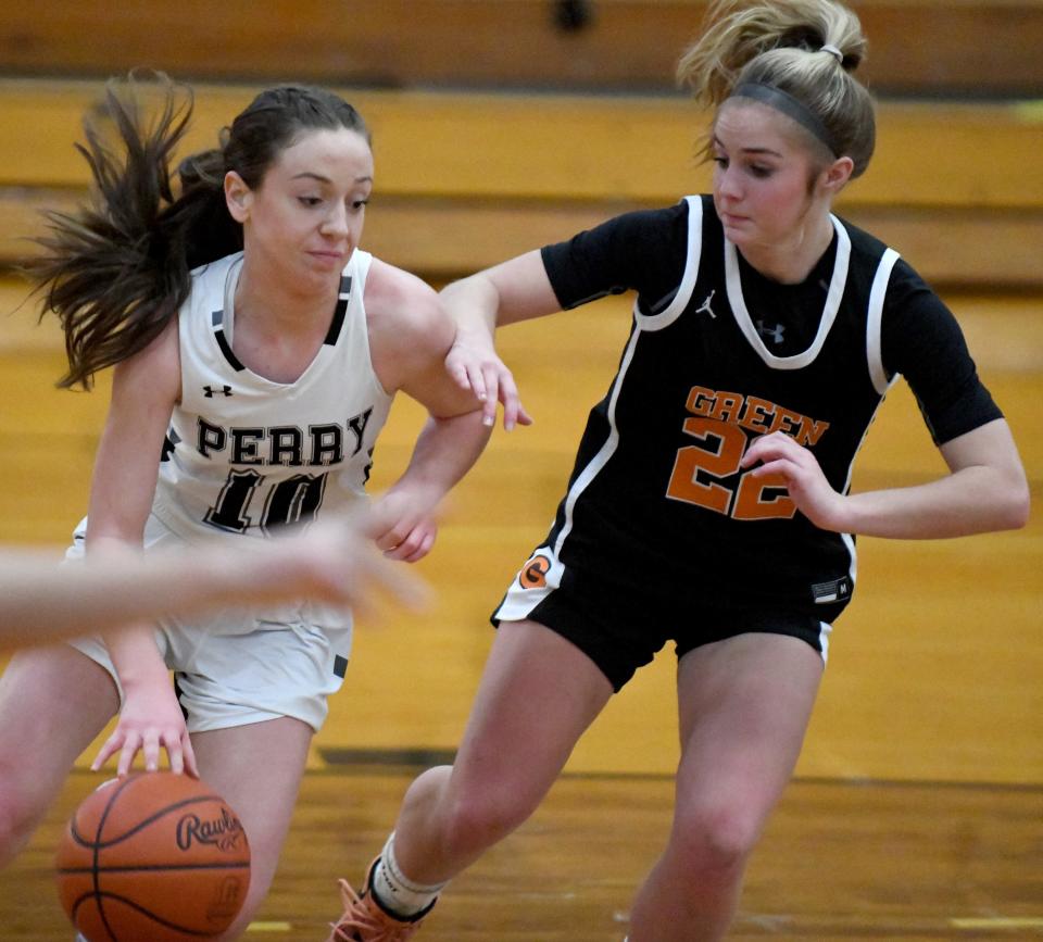 Perry's Marlee Pireu (left) looks for a lane past Green's Nina Shaffer during a game this season.