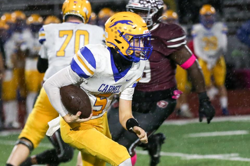 Carmel's Anthony Coellner (5) runs the ball during Lawrence Central vs Carmel IHSAA high school football, Oct 13, 2023; Indianapolis, IN, USA; at Lawrence Central High School.