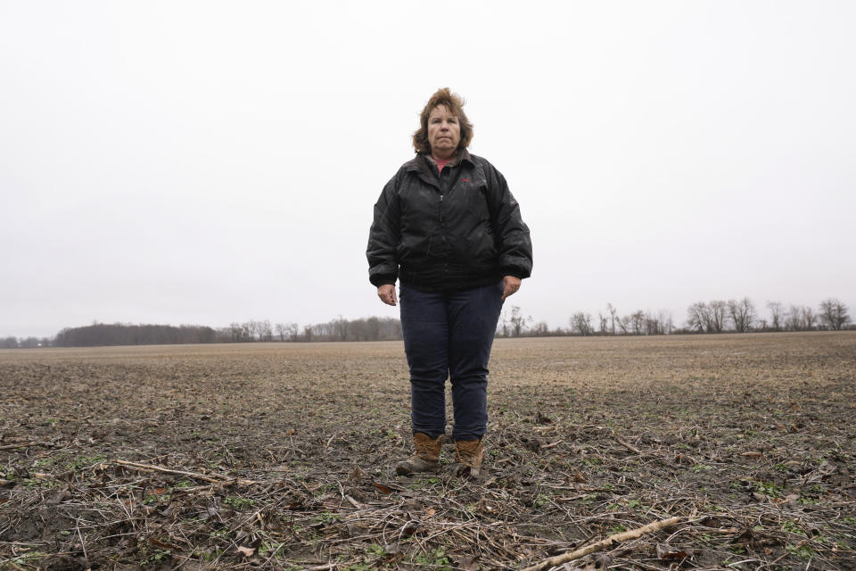 Clara Ostrander stands in her family's field in Maybee, Mich., Tuesday, Jan. 9, 2024. The family sought to lease some of the property for a solar energy project that would have paid enough to help them keep their land. Local opposition tanked the project and Ostrander now says there are neighbors she will never speak to again. (AP Photo/Paul Sancya)