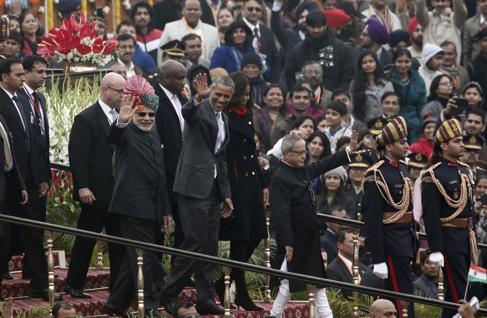 U.S. President Obama, flanked by India's PM Modi, the first lady Michelle Obama , and his Indian counterpart Mukherjee wave as they leave after attending the Republic Day parade in New Delhi