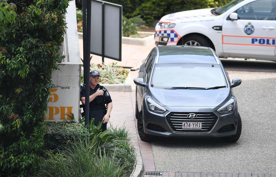 A police officer is seen outside the Chasely Apartments Hotel in Auchenflower in which two armed people are believed to be holed up. Source: AAP Image